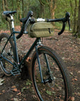 Commuter bum bag attached to adventure bike, forest setting.